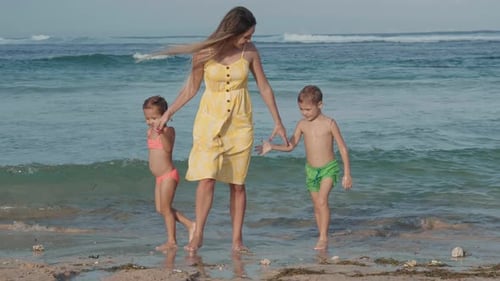 Young Woman and Her Children Walking on Coast