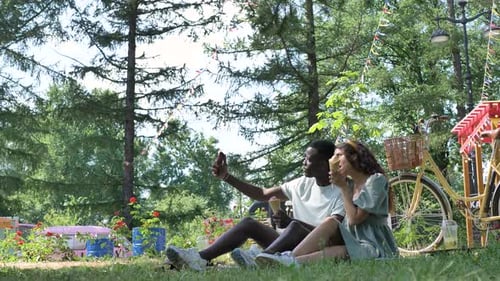 Couple Enjoying Ice Cream and Taking Selfie in Park