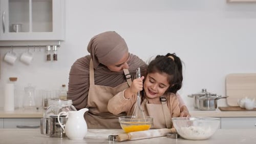 Mother In Hijab And Daughter Baking Making Dough In Kitchen
