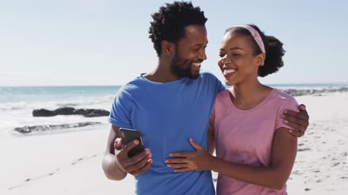 African american couple smiling taking selfie with smartphone on the beach