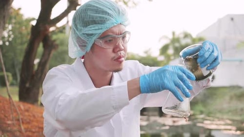 Academicians samples of factory wastewater a test tube for analysis in lab.