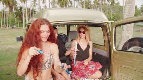 Three Friends Having Fun Blowing Bubbles on Vacation
