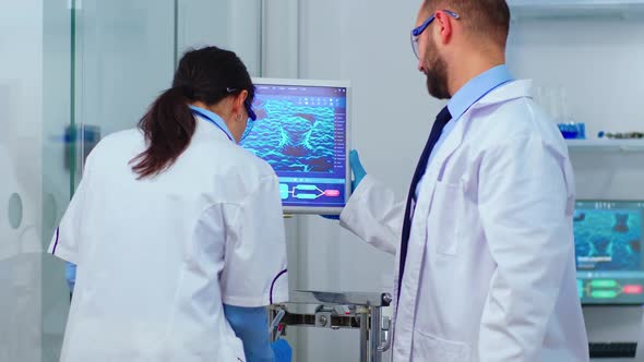 Scientist Team Arguing in Front of Computer Looking at Virus ...