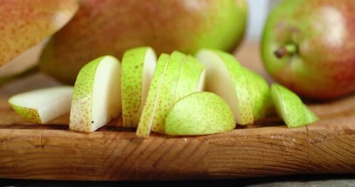 Chopped Pieces Ripe Pear on the Cutting Board Rotates Slowly.