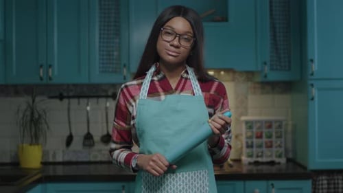 Woman Holding Rolling Pin in Kitchen