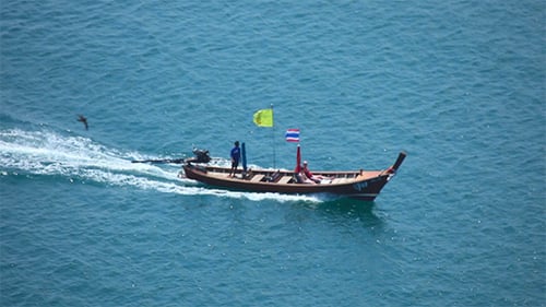 Wooden Boat Cruises on Teal Ocean Waters