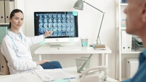 Doctor Explaining X-Ray to Patient in Office