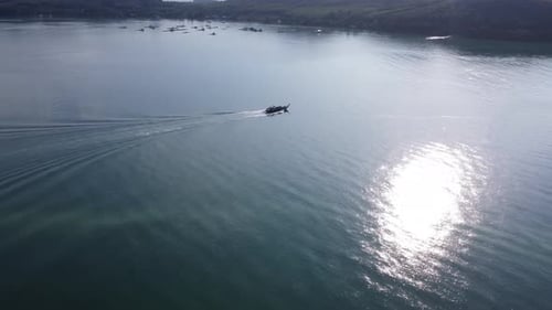 Aerial view from a drone of Thai traditional longtail fishing boats sailing in the sea.