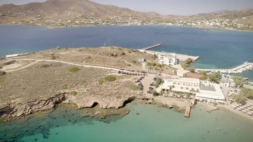 Aerial view of beach shore with rocks and very calm water in Greece.