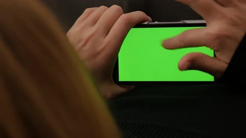 Blonde woman scrolling pages on smart phone or tablet PC green screen display 4K 2160p UHD video - B