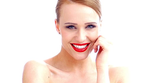 Woman Smiles with Red Lipstick in a Close Up