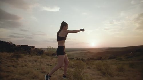 Woman Boxing Training at Sunset Outdoors