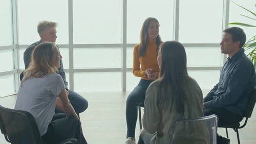 People Sitting in a Circle During a Group Therapy Session Communicate
