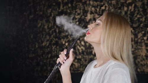 Blonde Woman Exhaling Smoke from Hookah Pipe