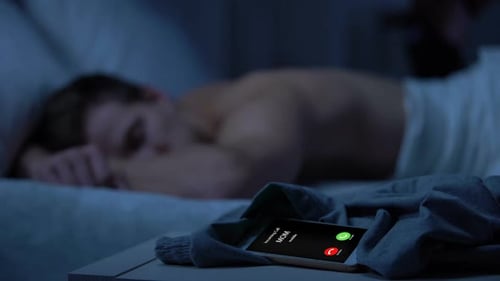 Mobile Phone Ringing in Dark Bedroom at Night