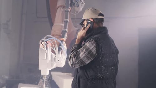 Craftsman Speaking on Smartphone in Workshop