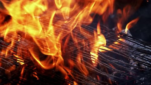 Bright Orange Flames Burning Over Metal Grill