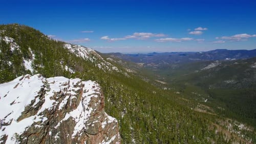 Aerial Drone Shot Flying Over Gorgeous Lush Green Wide Open Alpine Rocky Mountains Valley During Sun