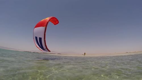 A young woman kite surfing in Egypt.