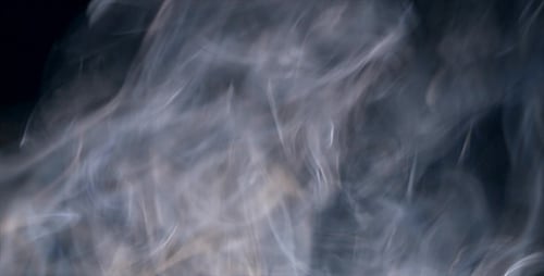 Abstract Smoke Forming Shapes in Dark Background