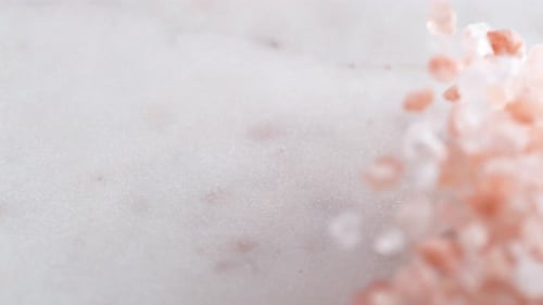 Pouring Pink Himalayan Salt Crystals Close Up