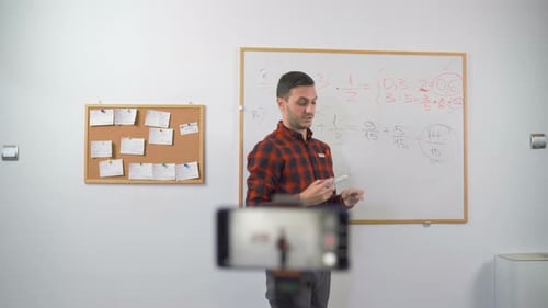 Man Teaching Math Lesson Using Whiteboard