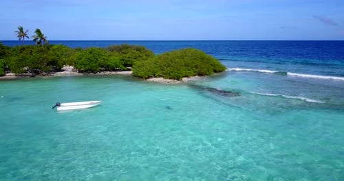 Wide angle overhead travel shot of a white sandy paradise beach and turquoise sea background in high