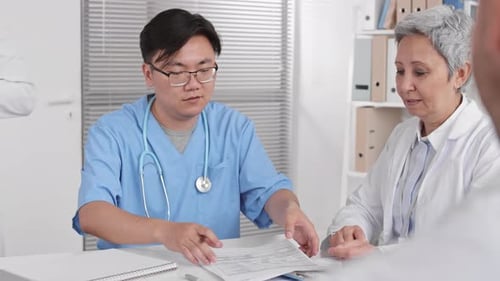 Medical Professionals Discussing Patient Care in Office Setting