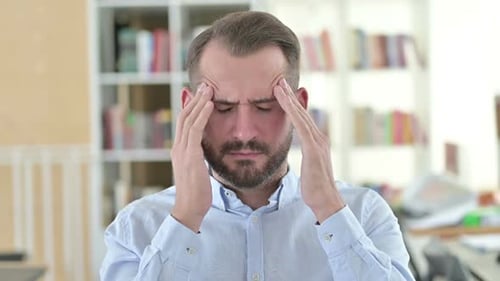 Man Massaging Temples in Pain from Headache