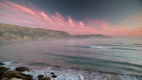 Waves Crashing on Rocky Coast at Twilight