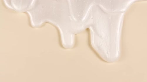 White Cosmetic Gel Fluid Cream With Molecule Bubbles Flowing On The Plain Beige Surface