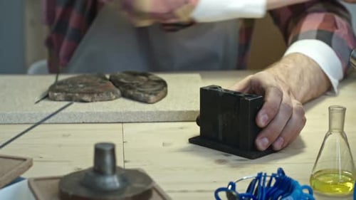Craftsman Working with Tools in Workshop