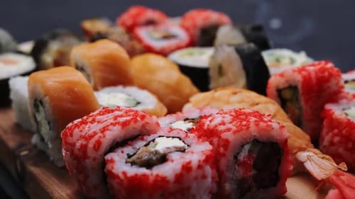 Assorted Sushi Rolls on Wooden Serving Board