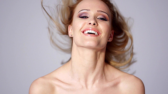 Beautiful Blond Woman Throwing Hair in Slow Motion
