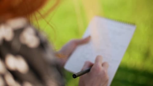 Mujer astuta en vestido blanco y negro escribiendo notas en cámara lenta