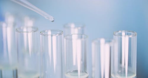 Extreme Close Up of Pipette Dropping Water Into Sample Tube at Laboratory