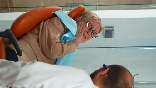 Vertical Video Woman with Toothache Talking with Orthodontic