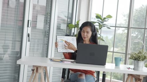 Woman Presents Data Online from Home Office