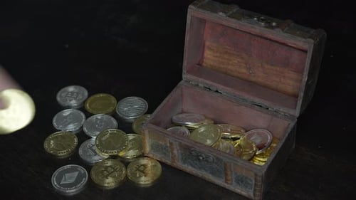 Cryptocurrency Coins Placed into Small Wooden Treasure Chest