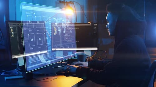 Man Coding with Holographic Computer Display at Night