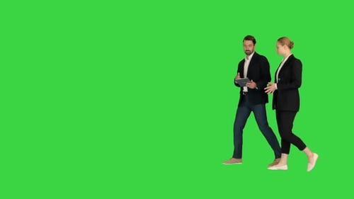 Two Business Partners Walking Using Tab and Talking To Each Other on a Green Screen Chroma Key