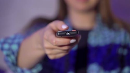 Woman Holding Remote Control Indoors