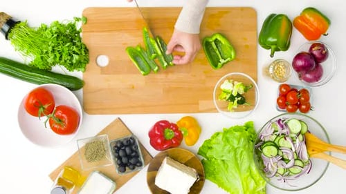Hands Dicing Green Pepper for Salad Preparation