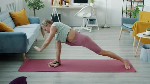 Woman Exercising Doing Yoga at Home