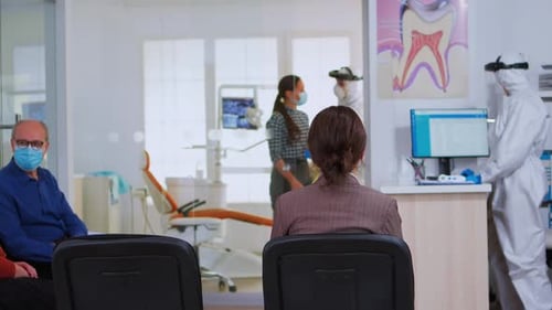 Dentist Office with Patients and Staff in PPE