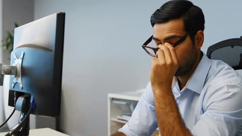 Young Adult Working at Computer in Modern Office