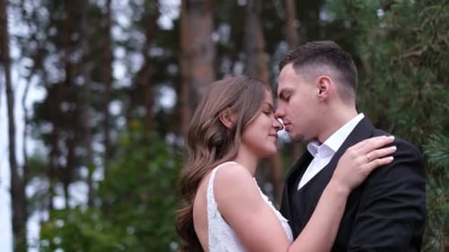 Newlyweds Share a Kiss in Forest