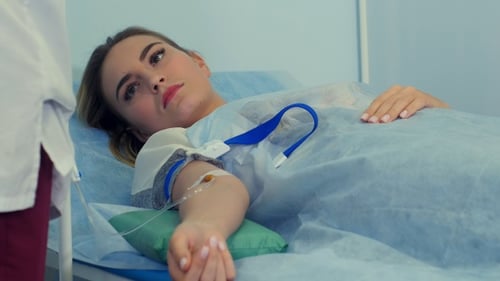 Skillful Nurse Putting Intravenous Injection on Female