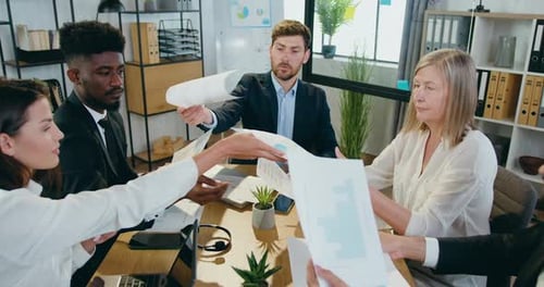 Diverse Team Collaborating on Data Analysis in Office