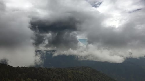 Dramatic Clouds Over Lush Green Mountain Range
